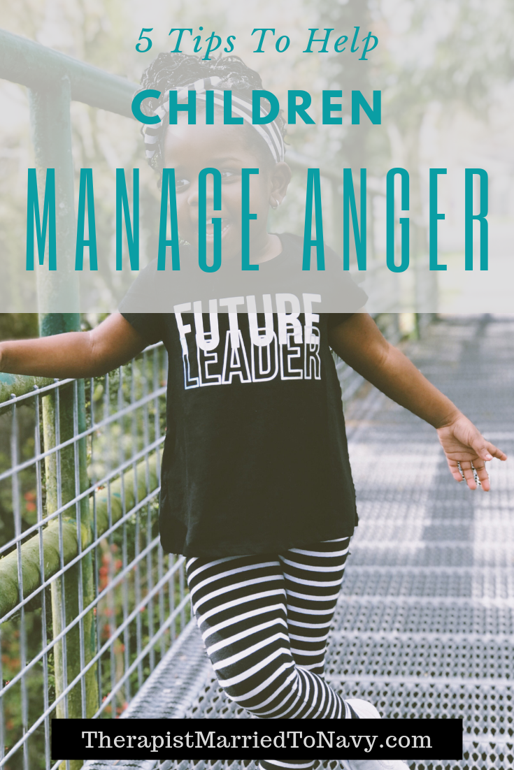 A young girl standing on a crosswalk. Her shirt says, Future Leader